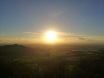 Scenic view of field against sky during sunset
