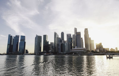 Buildings in city against cloudy sky