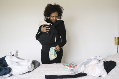 Woman with baby in bedroom