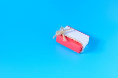 High angle view of red umbrella against blue background