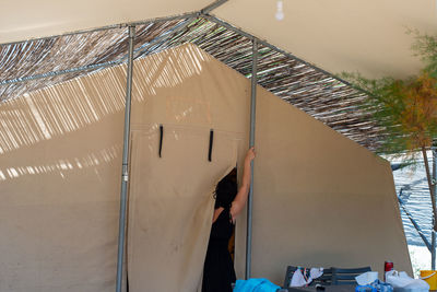 Rear view of man working on building