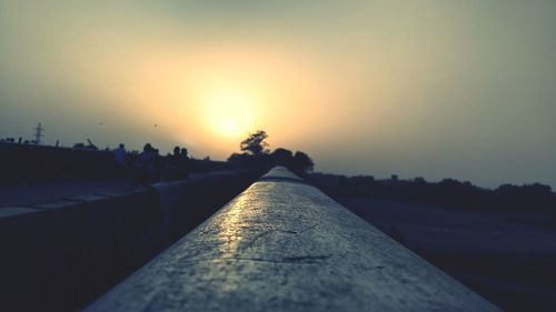 Surface level of retaining wall against clear sky during sunset