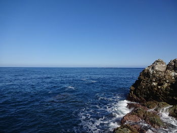 Scenic view of sea against clear blue sky