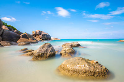 Panoramic view of rocks on beach against sky