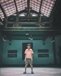 Full length portrait of boy standing on steps