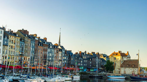 Buildings in city against clear sky