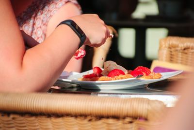 Midsection of woman preparing food in plate