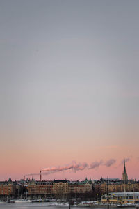 Buildings against sky at dusk during winter