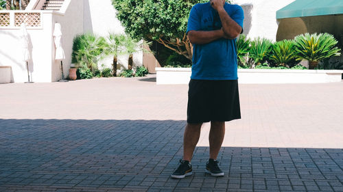 Low section of man standing on footpath