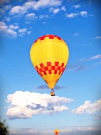Low angle view of hot air balloon against blue sky