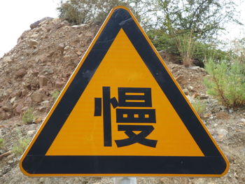 Close-up of road sign against trees