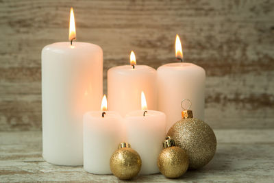 Close-up of lit candles on table