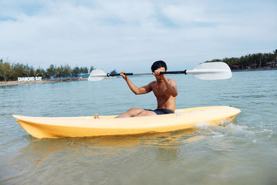 Man kayaking in lake