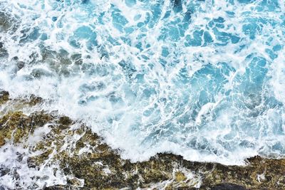 High angle view of waves splashing on shore