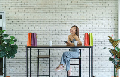 Full length of a young woman using laptop