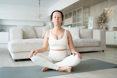 Pregnant woman meditating at home