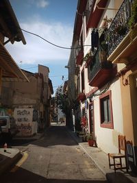 Street amidst buildings against sky in city
