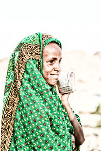 Portrait of mid adult man holding camera