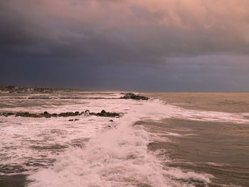 Scenic view of sea against dramatic sky