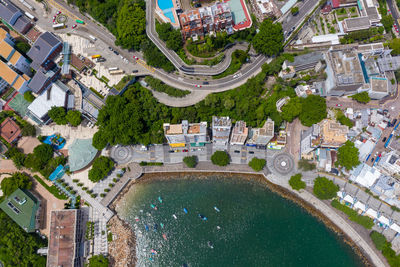 High angle view of swimming pool by buildings in city