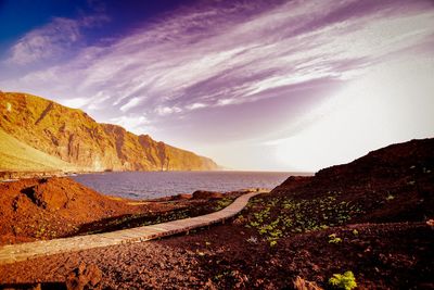 Panoramic view of sea and mountains against sky