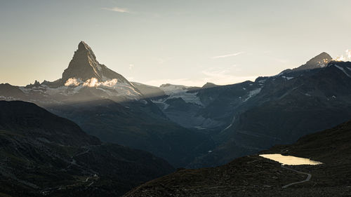 Scenic view of snowcapped mountains against sky during sunset