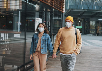 Couple wearing mask walking outdoors