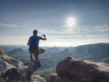 Full length of man on rock against sky