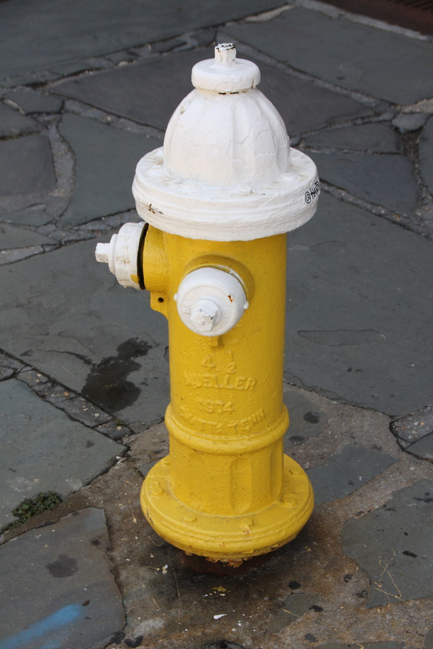 CLOSE-UP OF FIRE HYDRANT ON SIDEWALK