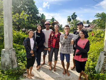 Portrait of young couple standing outdoors