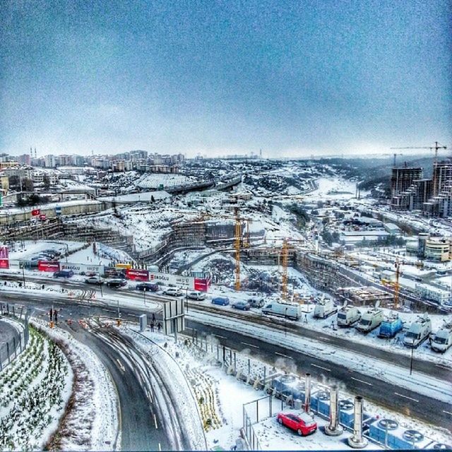 transportation, built structure, architecture, mode of transport, building exterior, winter, high angle view, city, cold temperature, clear sky, snow, land vehicle, car, road, blue, sky, copy space, day, outdoors, no people