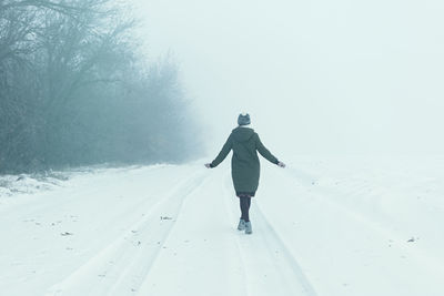 Young woman winter landscape. a beautiful brunette enjoys the first fluffy clean snow 