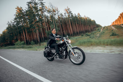 Man riding motorcycle on road