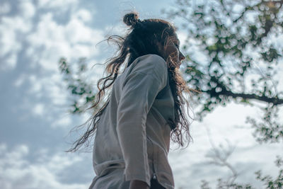 Woman dancing against sky