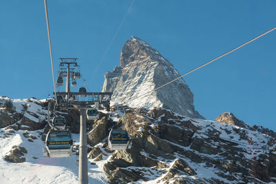 High angle view of snow covered mountain against blue sky