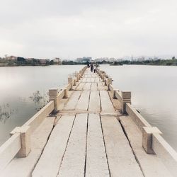 Pier over lake against sky