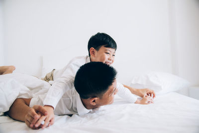 Friends lying on bed