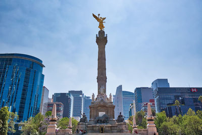 Low angle view of statue of historic building against sky