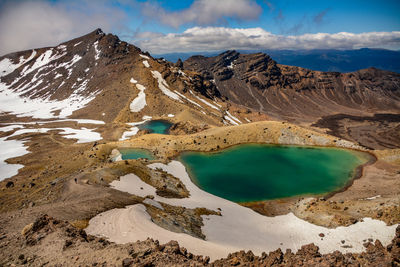 High angle view of lake amidst mountains during winter