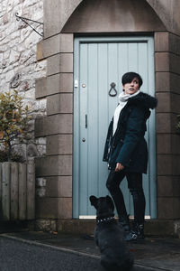 Portrait of man standing against wall