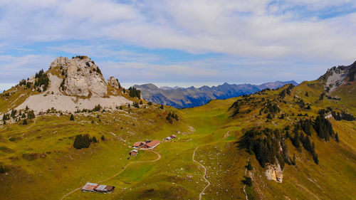 Scenic view of land and mountains against sky