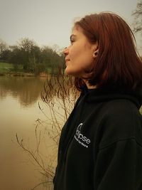 Side view of young woman looking away in lake