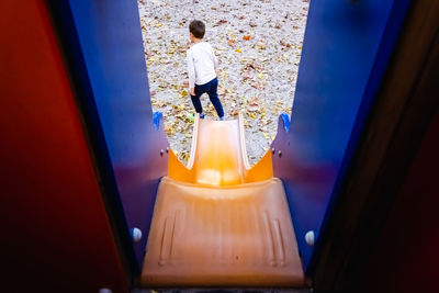 High angle view of child standing in corridor