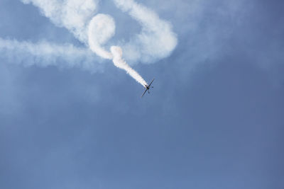 Low angle view of airplane flying in sky