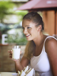 Young woman holding milk glass