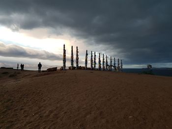 People on beach against sky