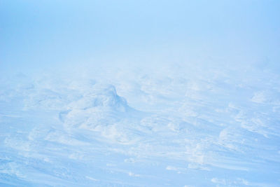 Like aerial view of snow covered landscape against clear blue sky