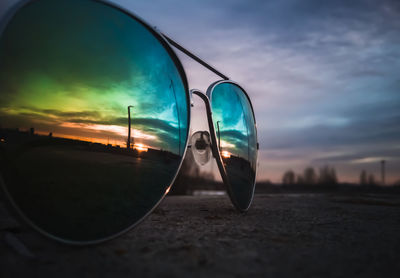 Close-up of sunglasses on side-view mirror