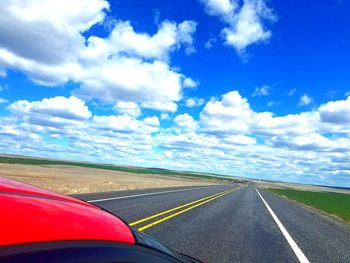 Road by landscape against sky