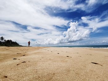 Man on beach against sky